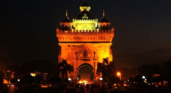 Tranquil Vientiane cityscape at dawn for a Vientiane Tours banner by Legend Travel Group.